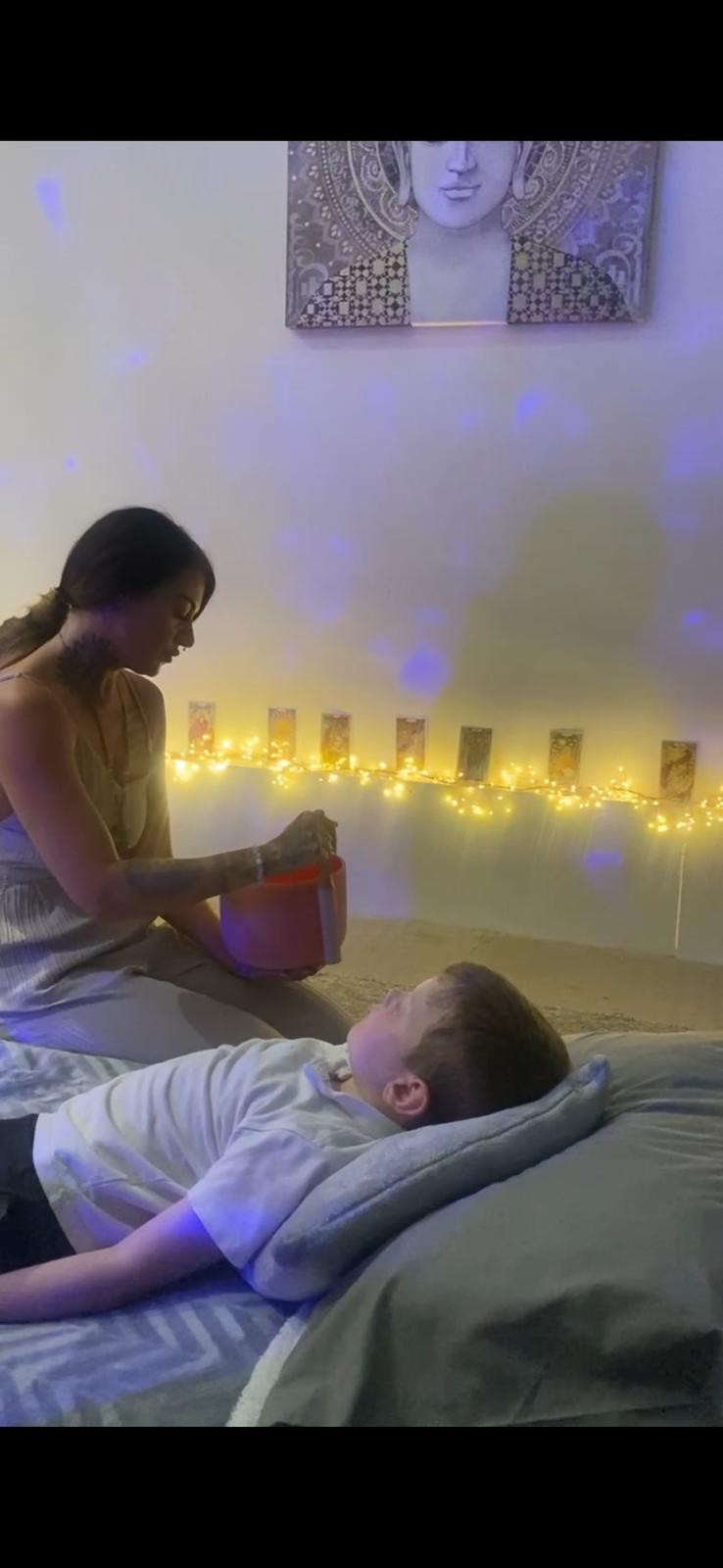 Kate using a singing bowl during a healing session